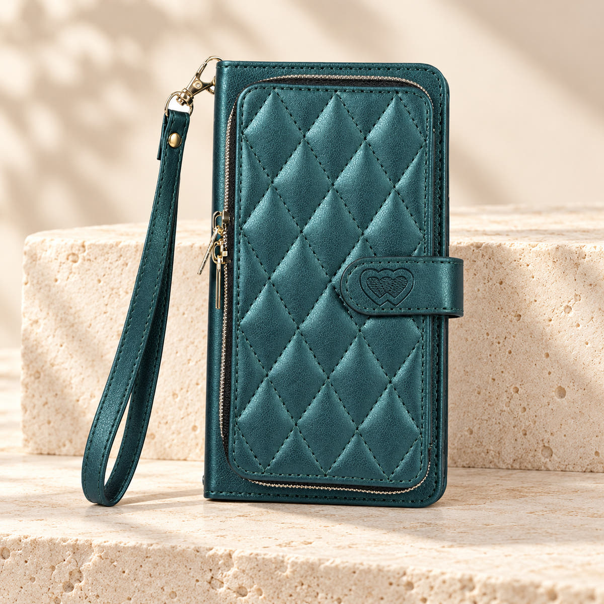 Forest Green padded zip iPhone wallet case with matching wrist strap on limestone