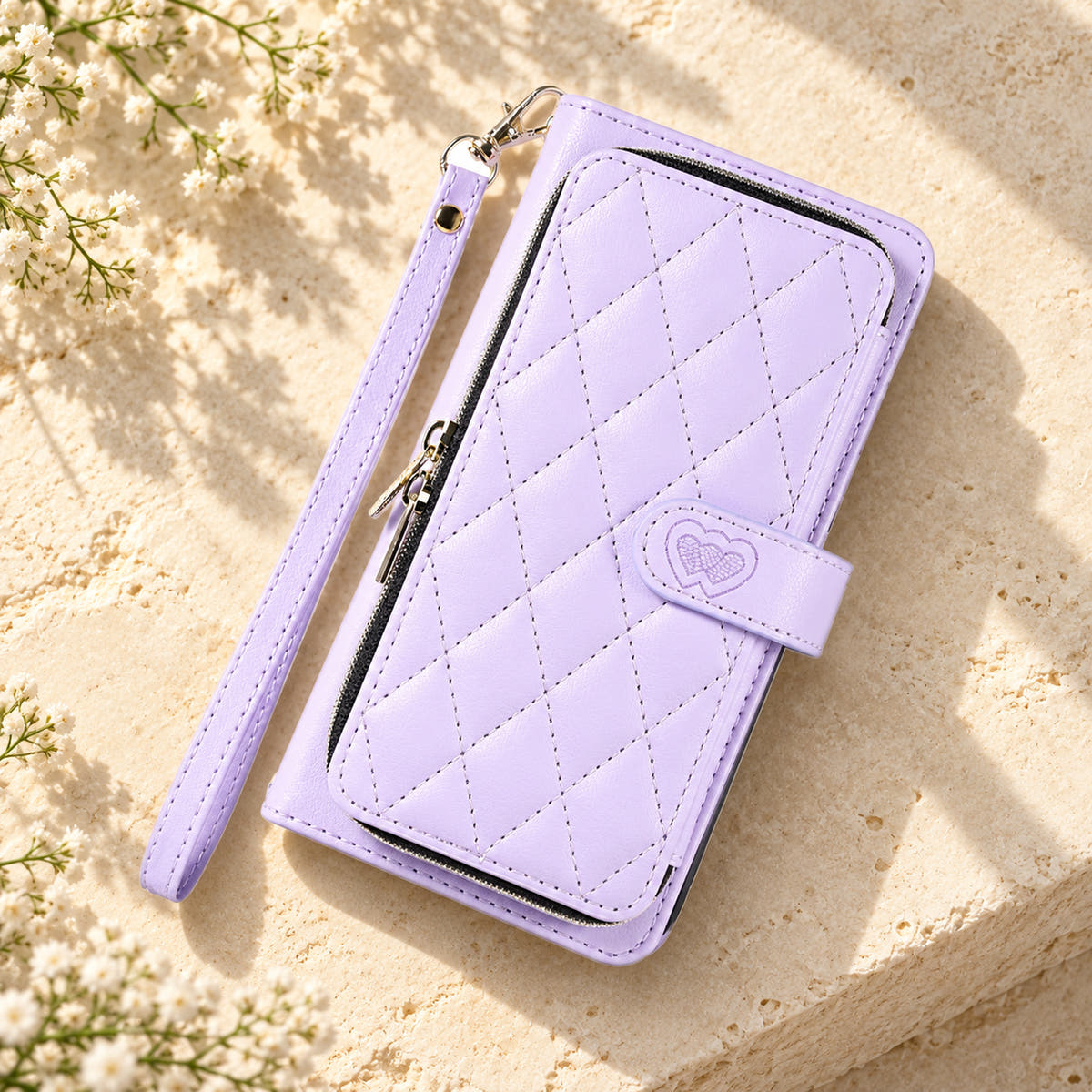 Lavender padded zip wallet in an angled flat lay showing quilted front and closure