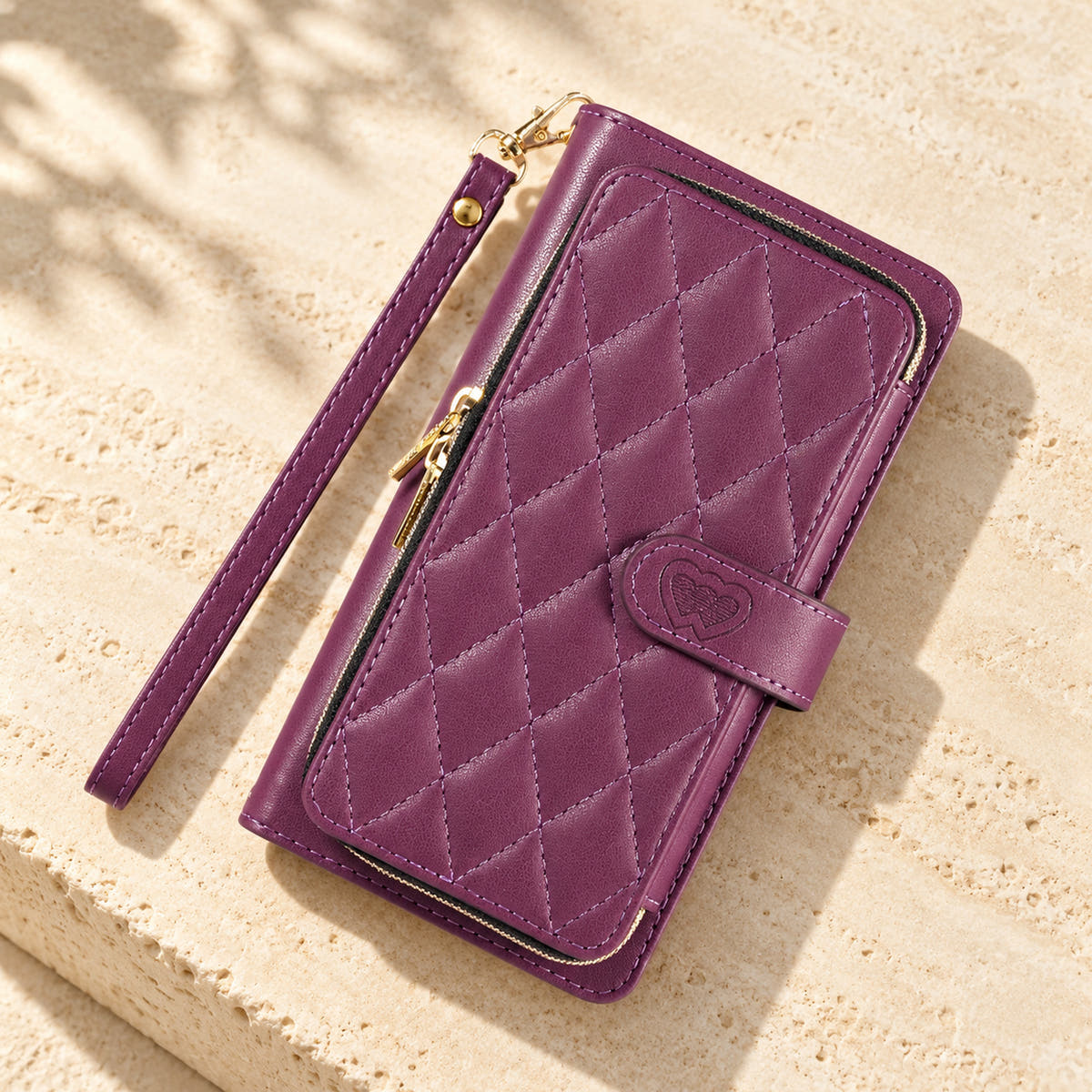 Purple padded zip wallet in an angled flat lay showing quilted front and closure