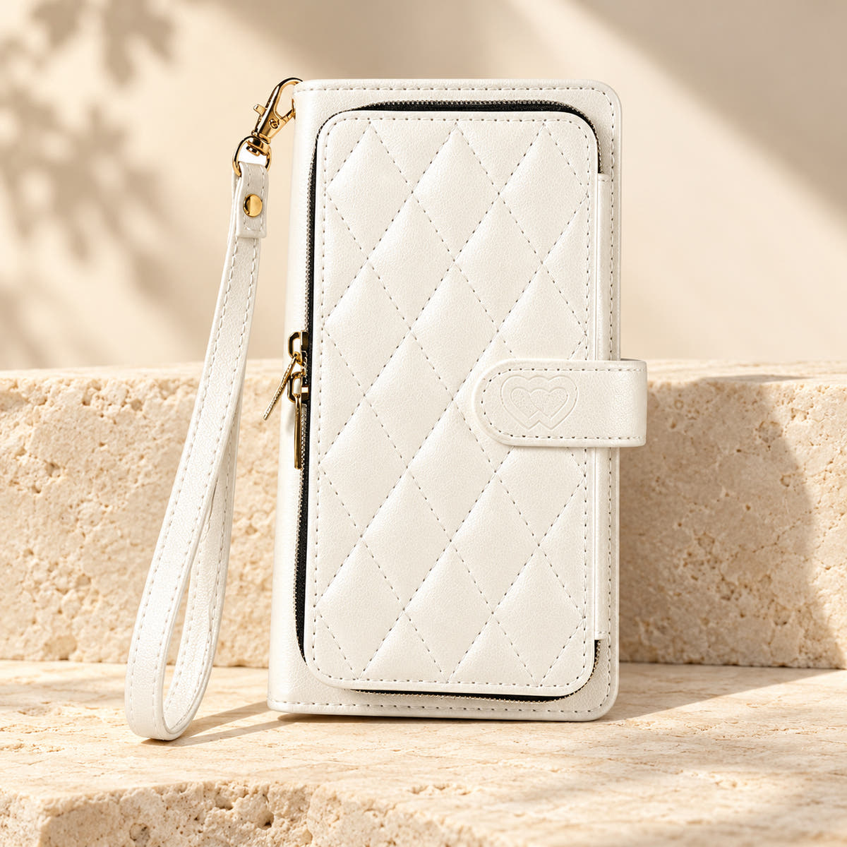 White padded zip iPhone wallet case with matching wrist strap on limestone