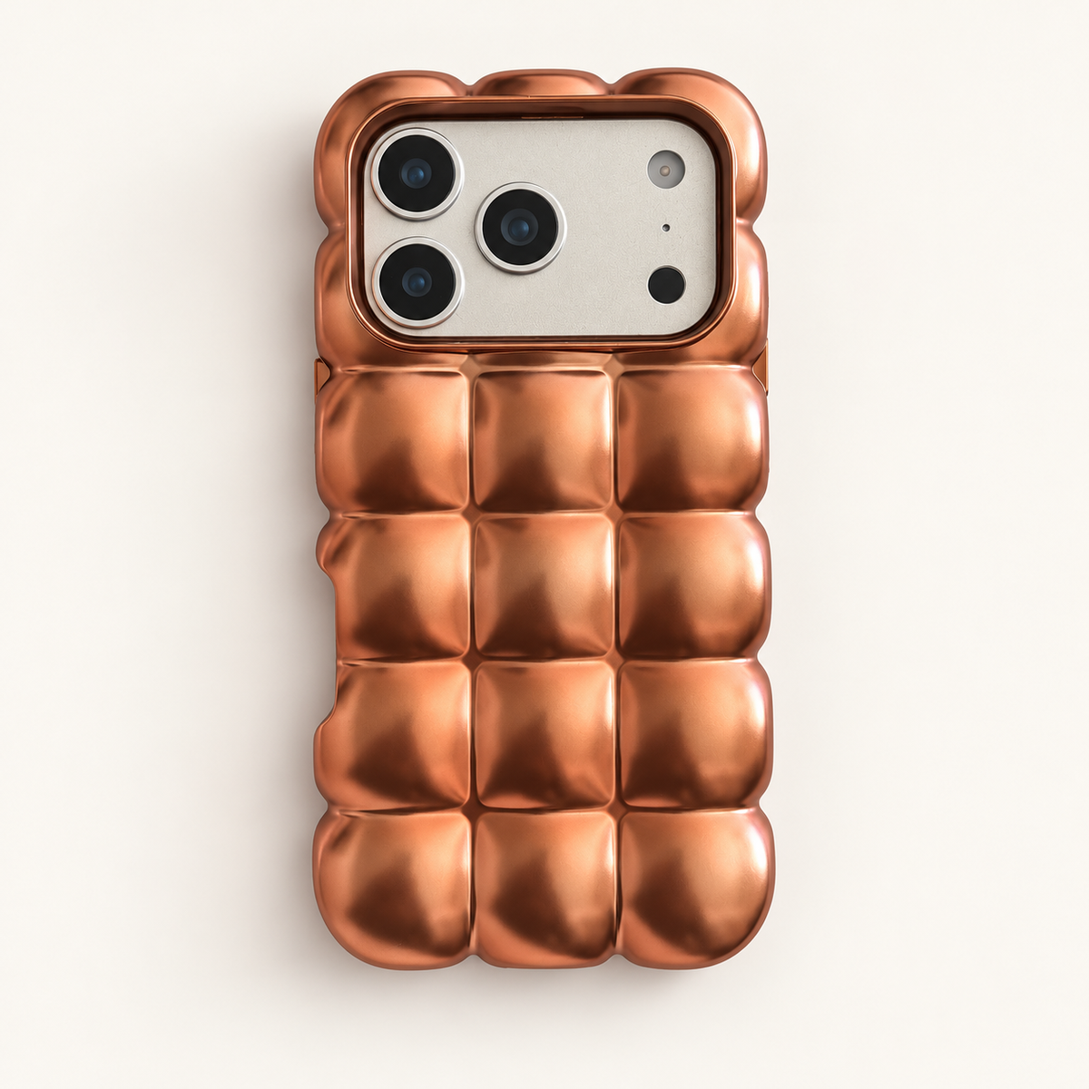 Copper puffy grid iPhone case with rounded-square back and scalloped edges — full rear studio view.