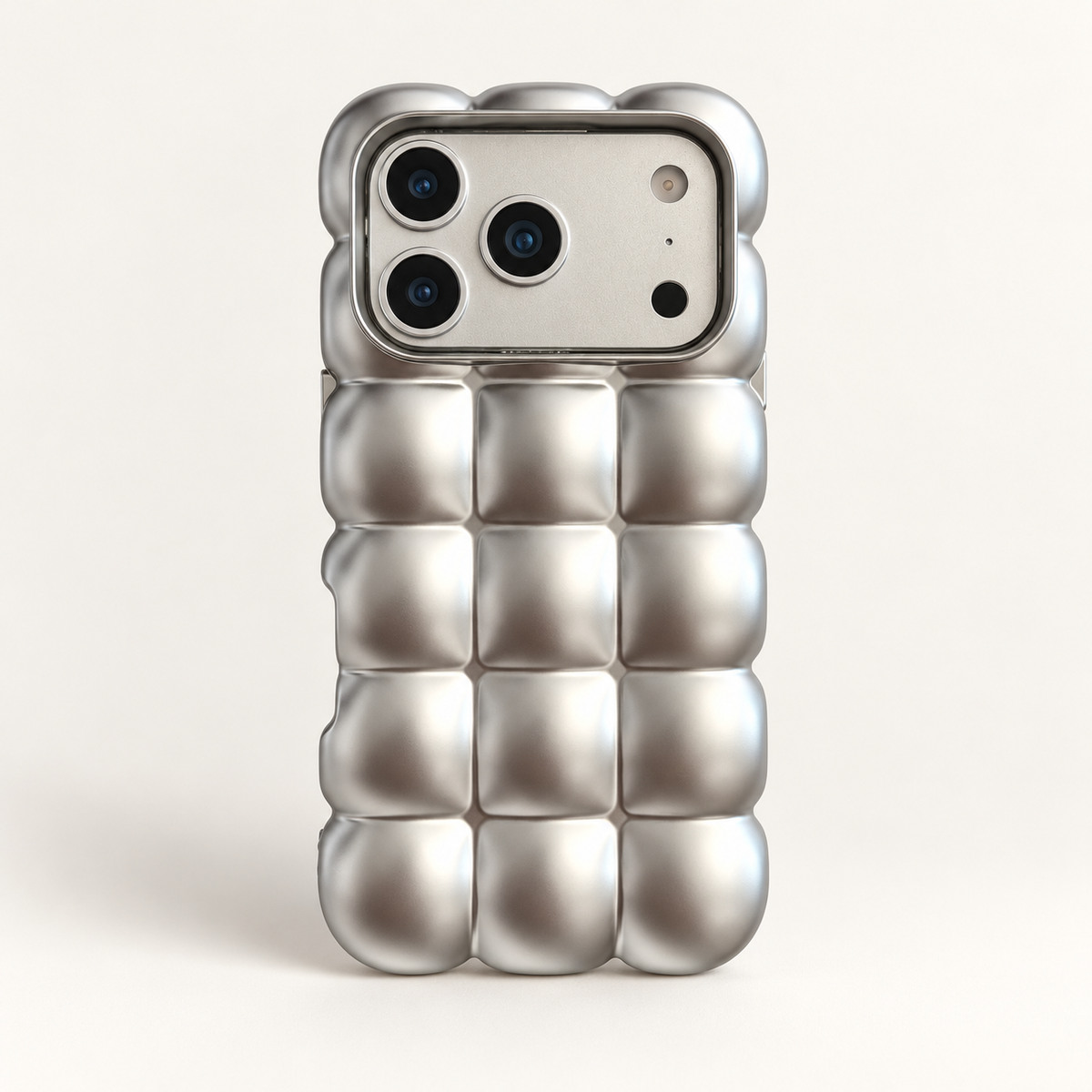 Satin Silver puffy grid iPhone case with rounded-square back and scalloped edges — full rear studio view.
