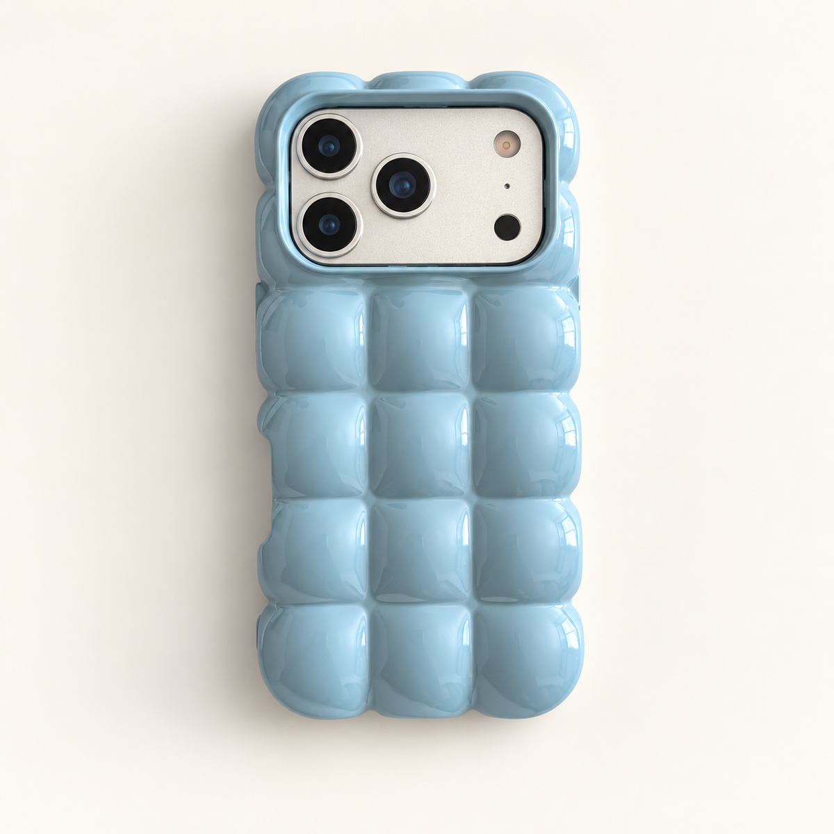 Sky Blue puffy grid iPhone case with rounded-square back and scalloped edges — full rear studio view.