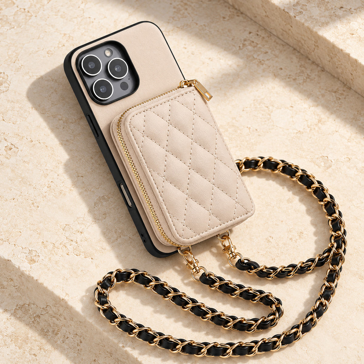 Beige quilted iPhone wallet case — quilted wallet and woven chain on a tabletop
