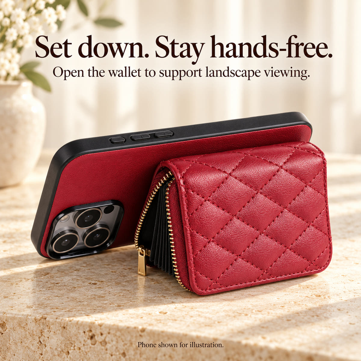 Red quilted iPhone wallet case propped horizontally using its open accordion wallet as a stand