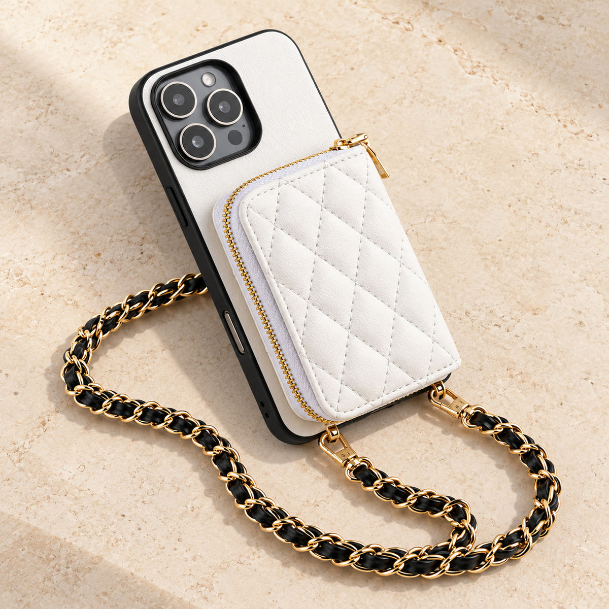 White quilted iPhone wallet case — quilted wallet and woven chain on a tabletop