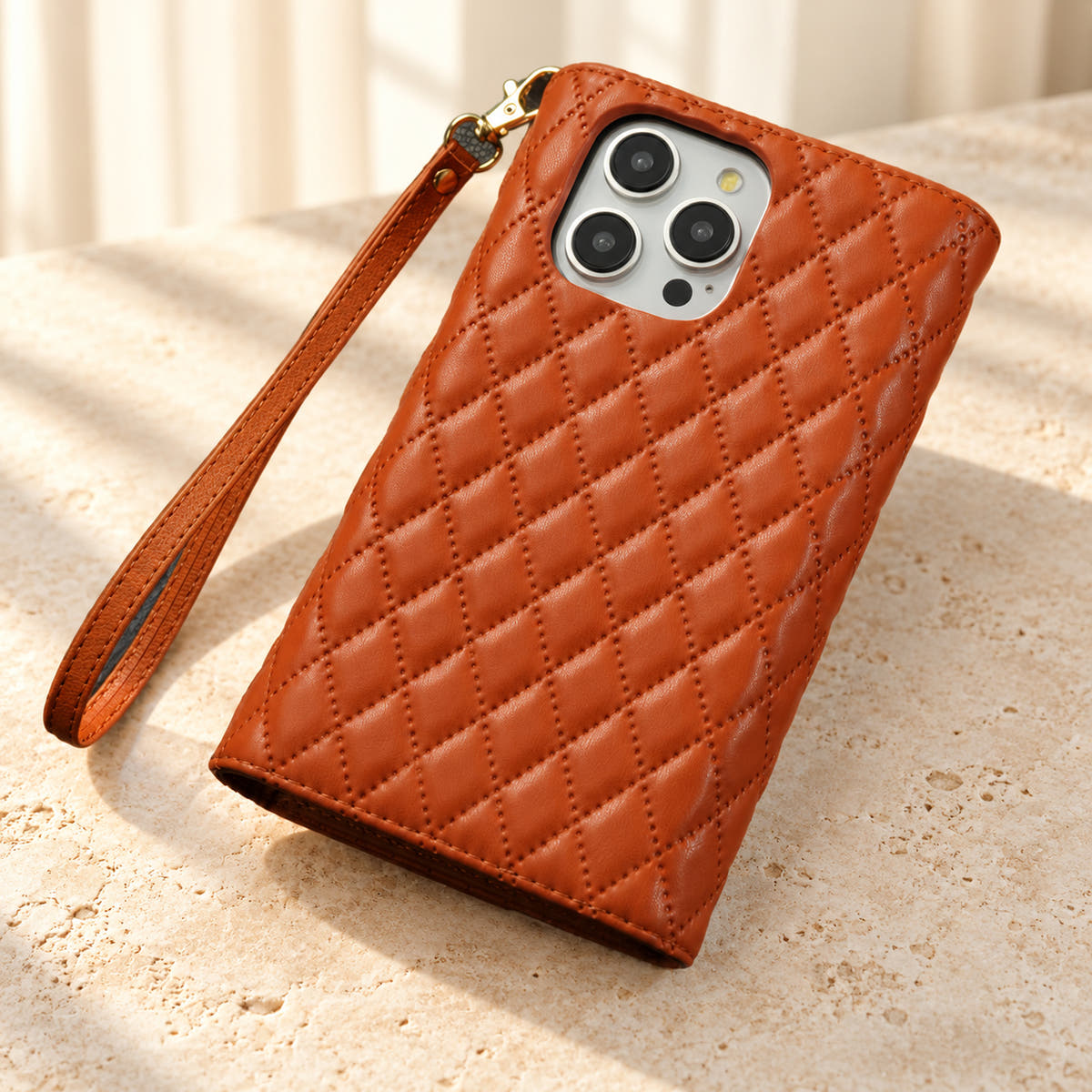 Rear view of the Brown Quilted Zip Wallet iPhone case, showing the diamond-quilted back, camera opening and detachable wrist loop.