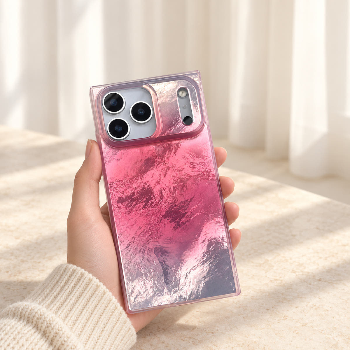 Radiant Wave iPhone case held against ivory curtains with pink-to-silver reflections