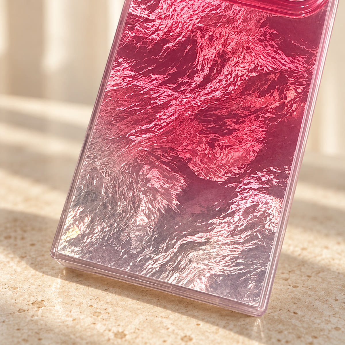 Close-up of the Radiant Wave case pink-to-silver rippled finish and lower edge