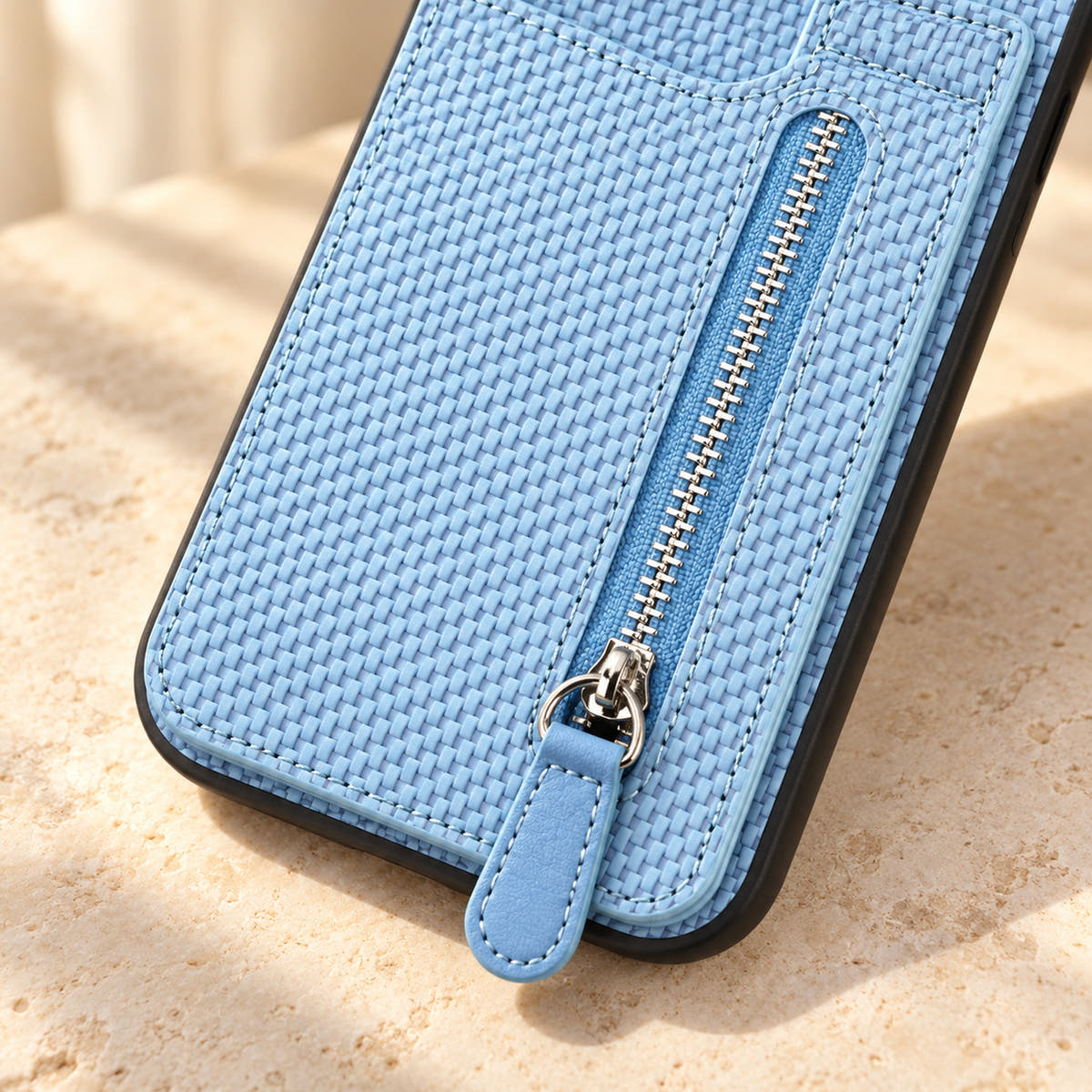 Signature Blue iPhone wallet case in a close-up of the zipper, matching pull tab and woven-look texture.