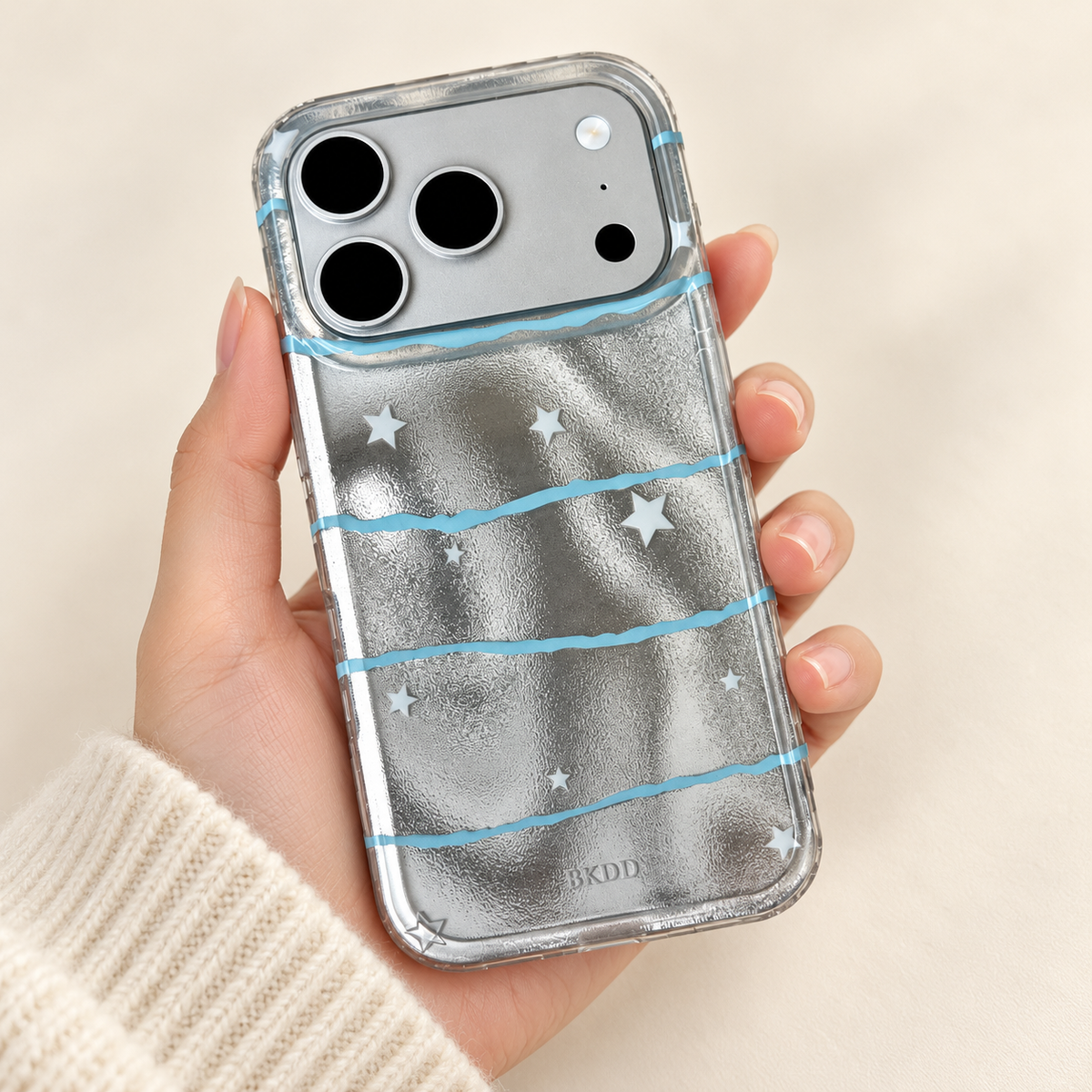 Silver Star Wave case resting across one hand, viewed from above with its full design visible.