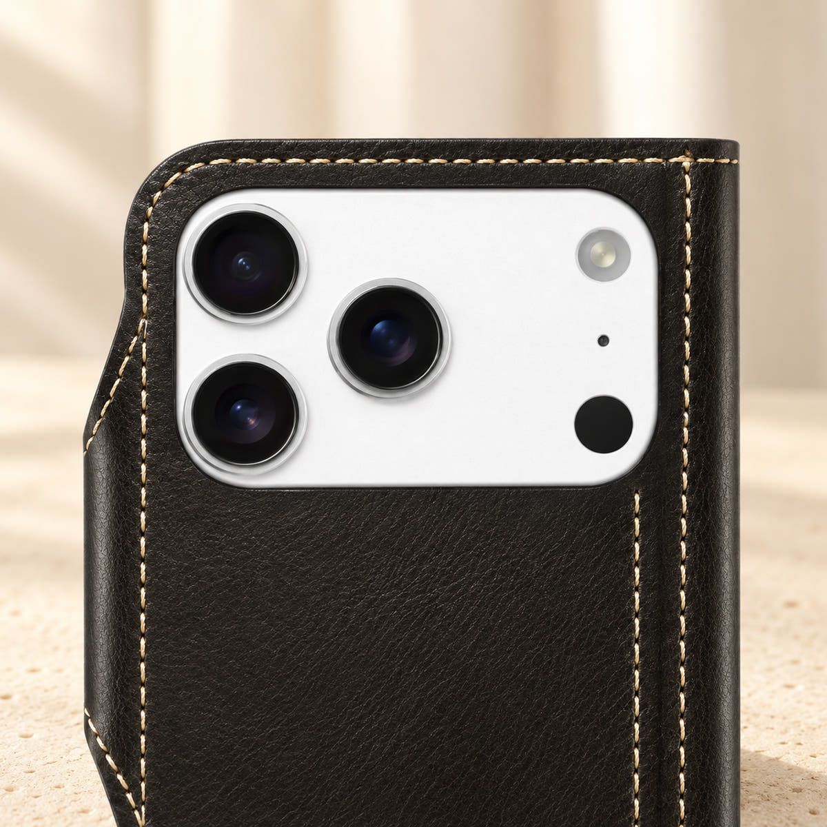 Black wallet case camera detail showing the source-specific camera opening and cream stitched border