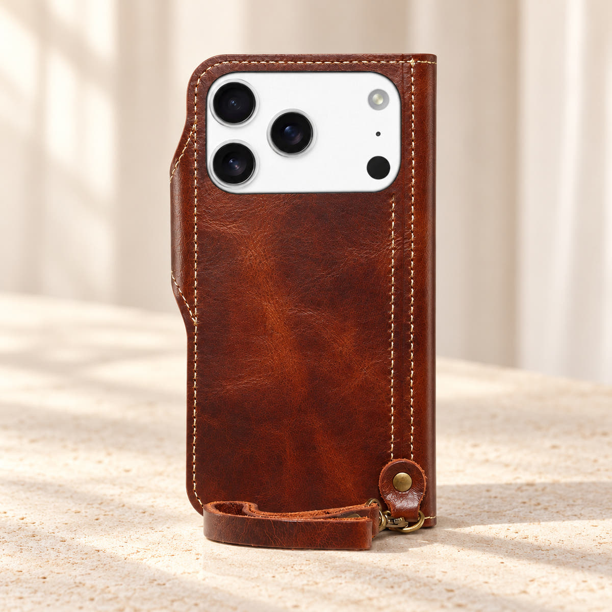 Brown stitched wallet case rear view with the original camera opening and matching clip-on wrist loop