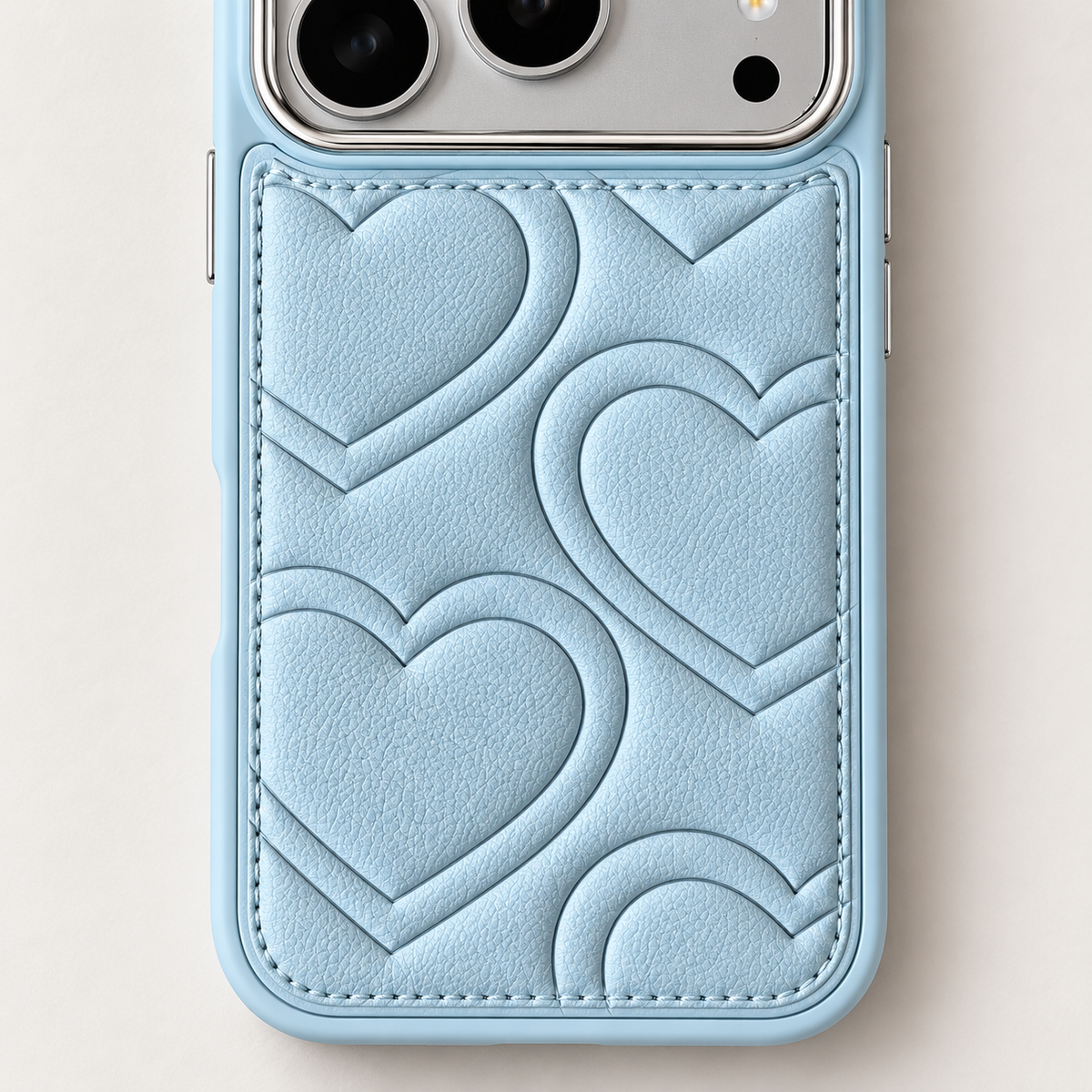 Textured heart iPhone case in Sky Blue — heart pattern and stitched border close-up.