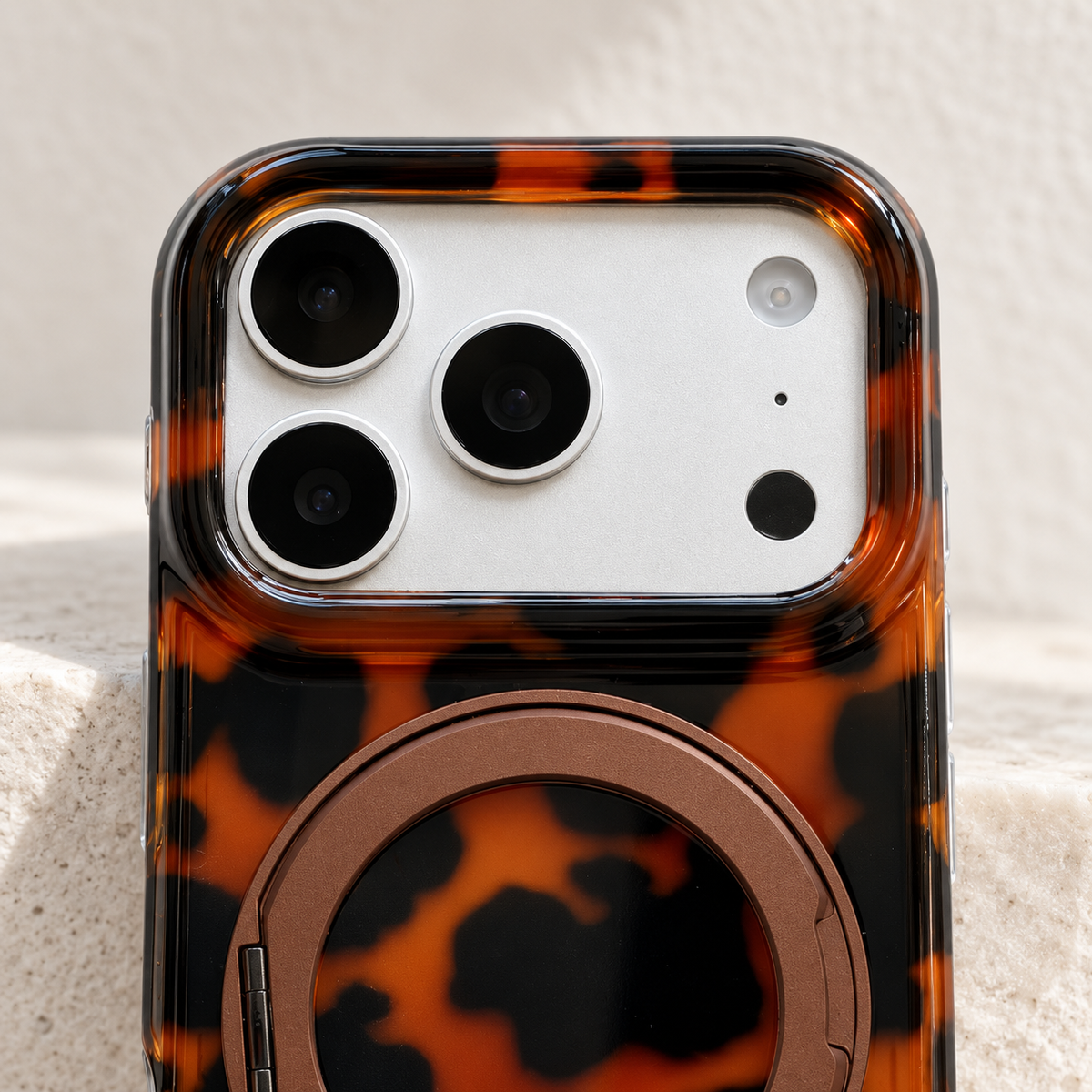 Detail of the Amber tortoiseshell case around its model-specific camera opening.
