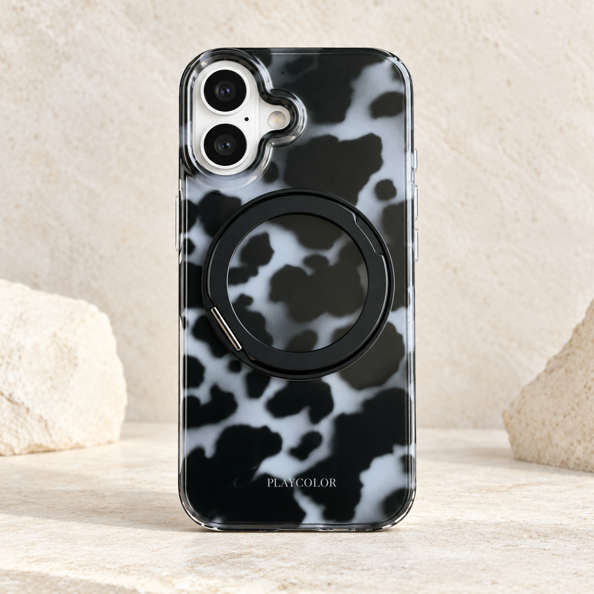 Grey tortoiseshell iPhone case with black fold-out ring closed against the patterned back.