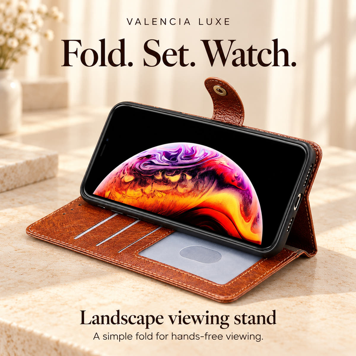 Brown Valencia Luxe wallet phone case folded into a landscape viewing stand on a cream tabletop.