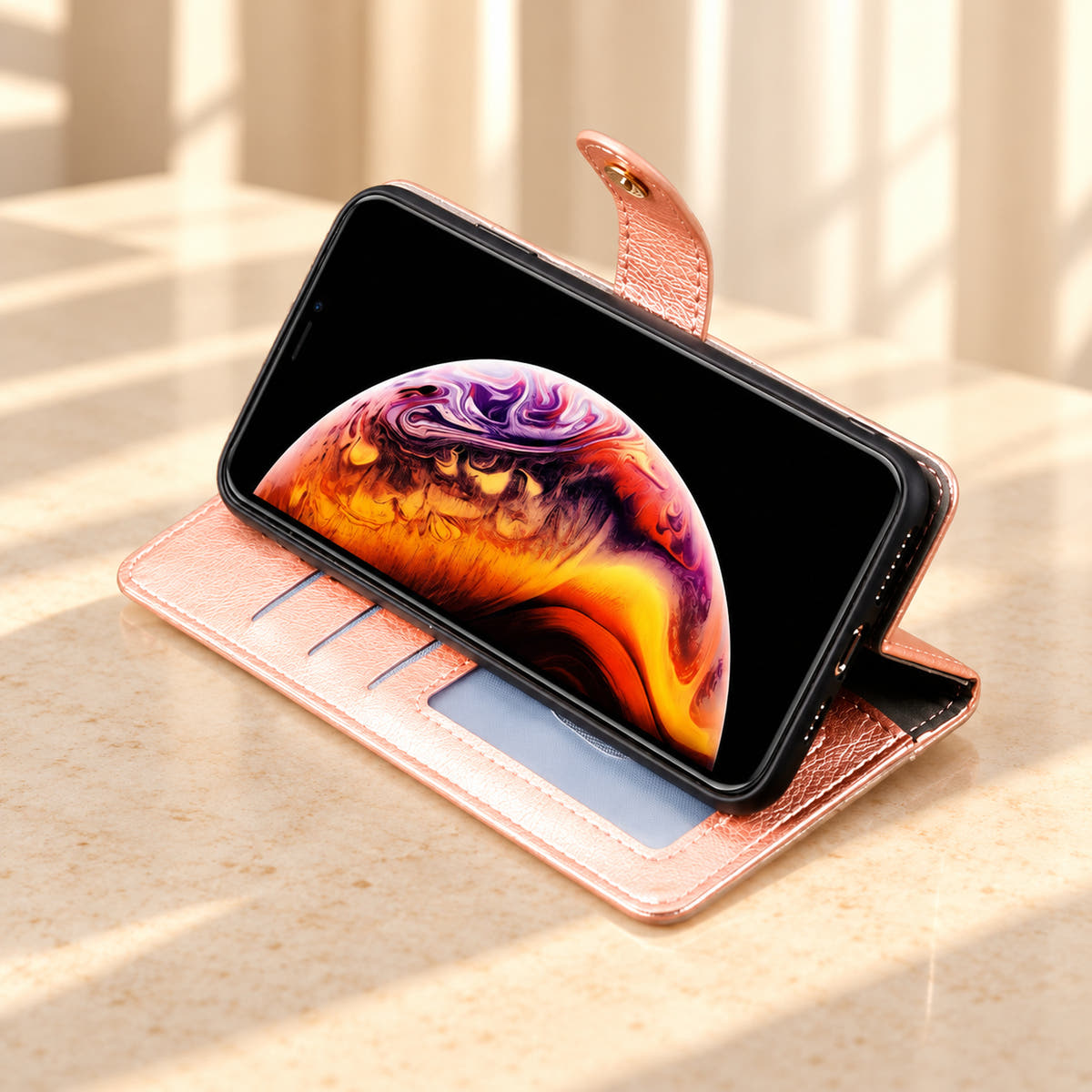 Valencia Luxe pink wallet phone case folded into a landscape viewing stand on a cream limestone surface.