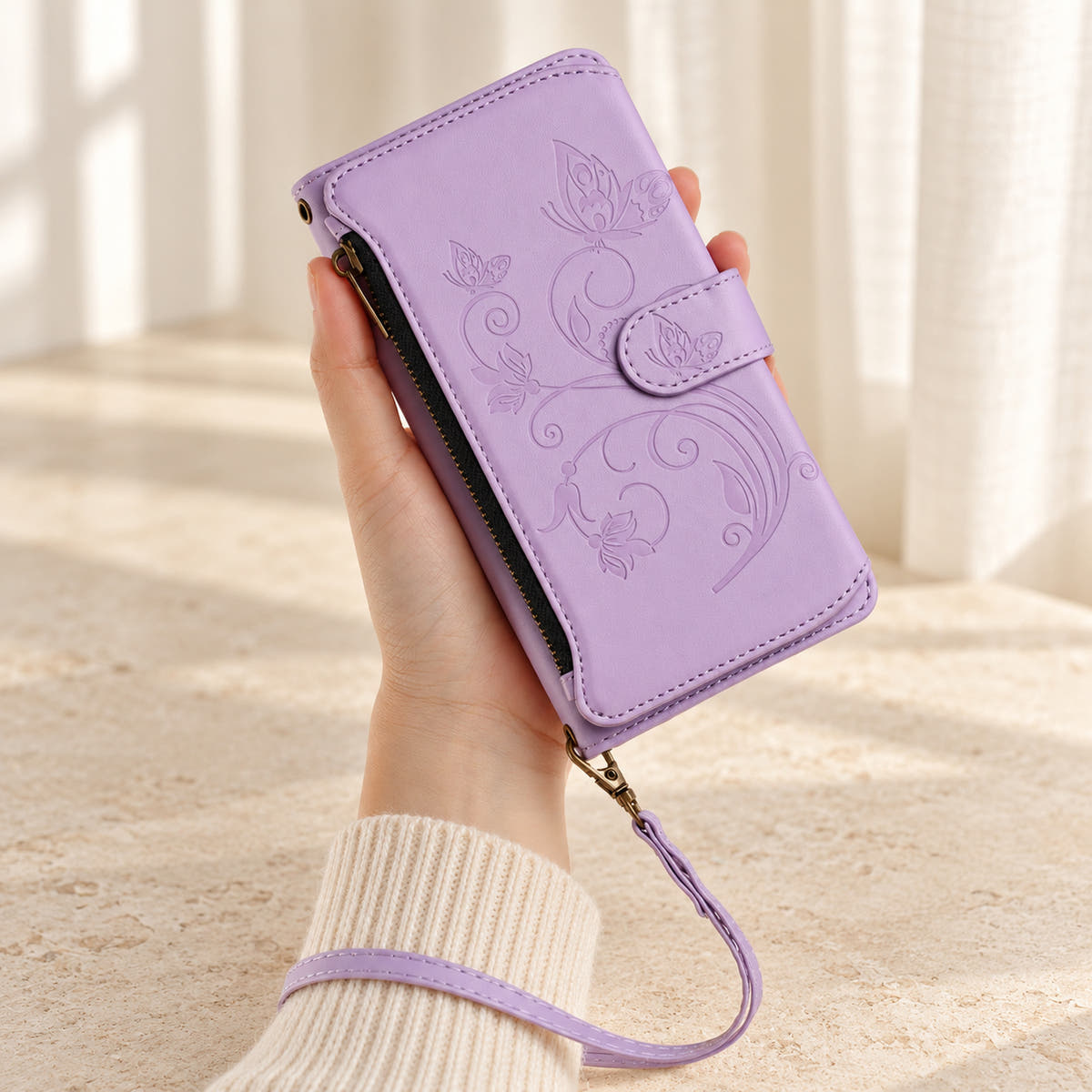 Velora Zip iPhone wallet case in Lavender, handheld with embossed butterfly front, side zip and matching wrist strap.