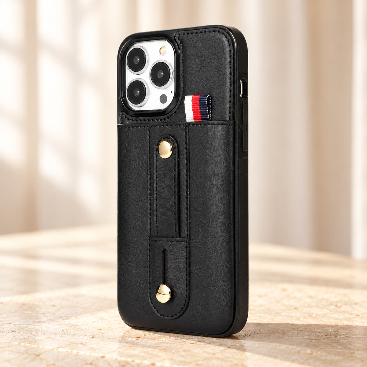 Black iPhone wallet case with card pocket and adjustable hand strap, angle