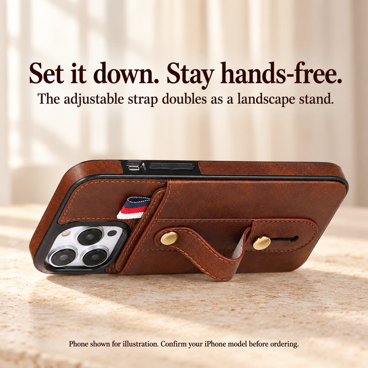 Brown iPhone wallet case propped horizontally on its existing bowed hand strap