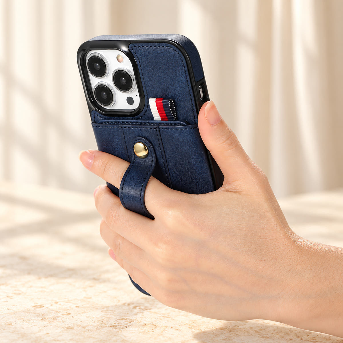 Navy Blue iPhone wallet case with card pocket and adjustable hand strap, handgrip