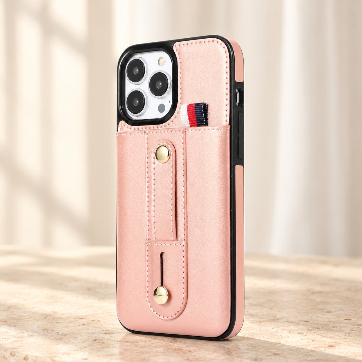 Pink iPhone wallet case with card pocket and adjustable hand strap, hero