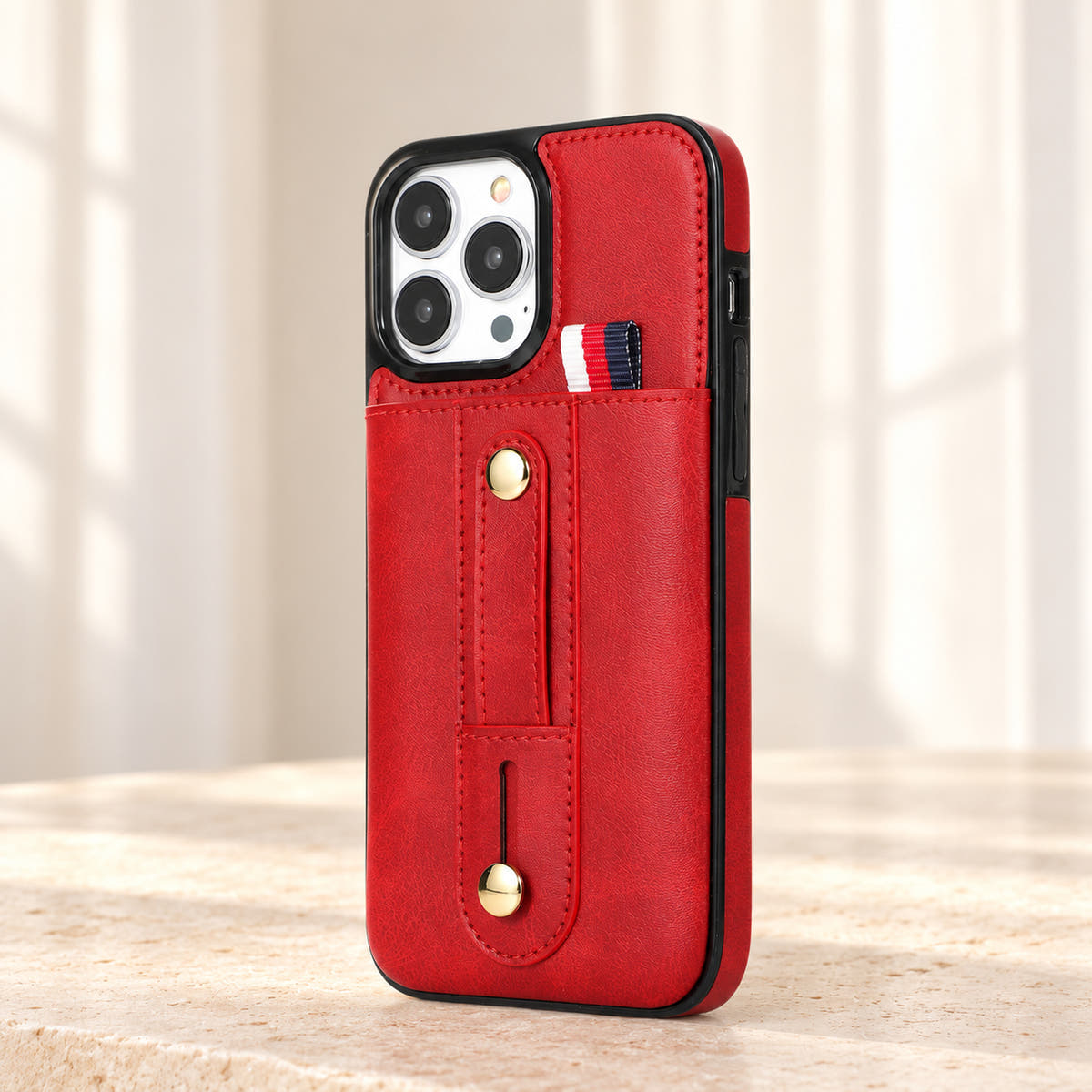 Red iPhone wallet case with card pocket and adjustable hand strap, hero