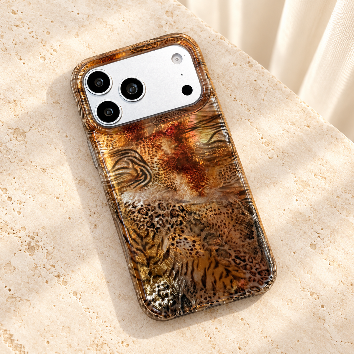 Animal Mix Amber Shimmer iPhone case in an overhead flat-lay on cream stone.