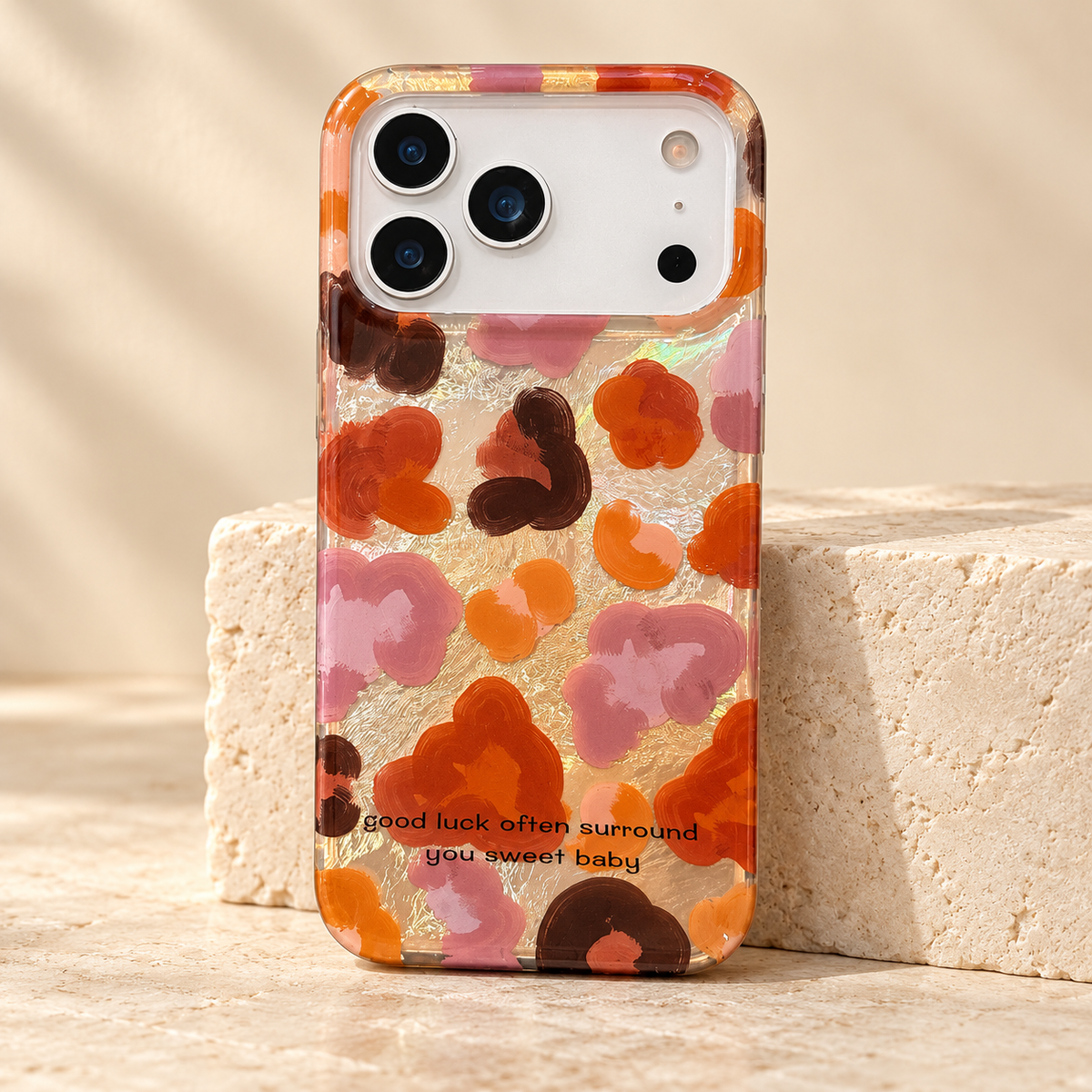 Autumn Mix floral iPhone case with a glossy light-catching background, rust, mauve and cocoa print, and amber-tinted edges.