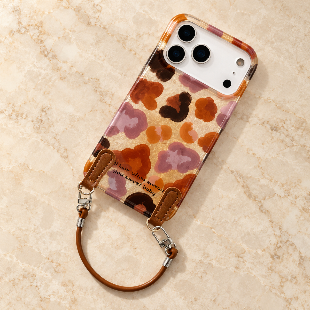 Overhead styling of the Autumn Mix case with its pictured brown wrist loop and two silver-tone clips.