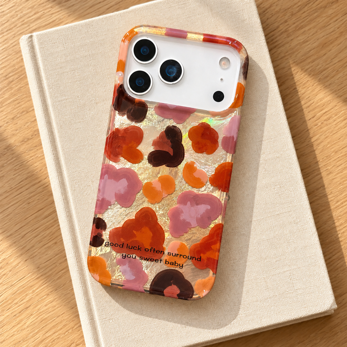 Autumn Mix floral case styled on a plain cream notebook on a light oak table.