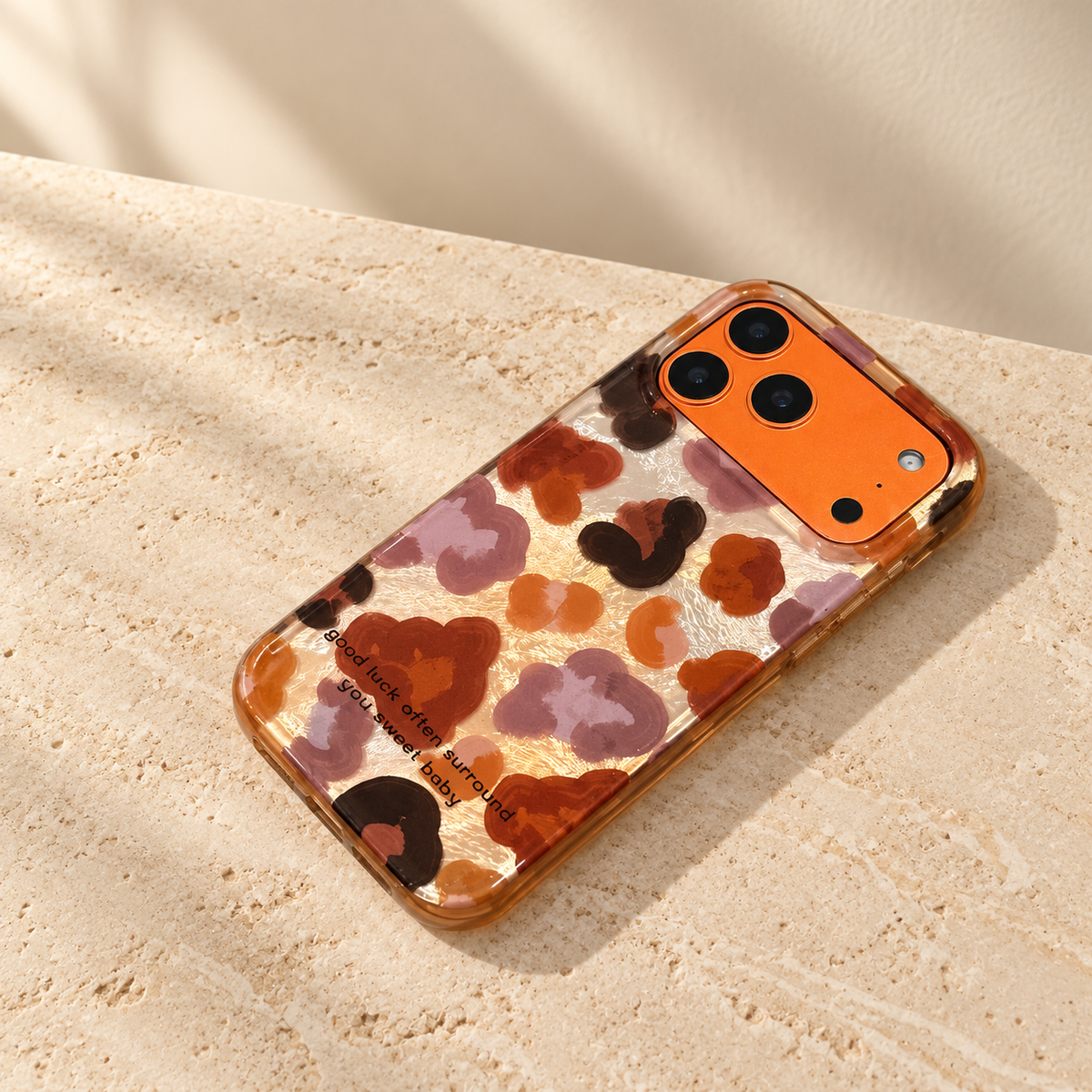 Shallow angled view of the Autumn Mix floral case showing its glossy back and amber-tinted side edge.