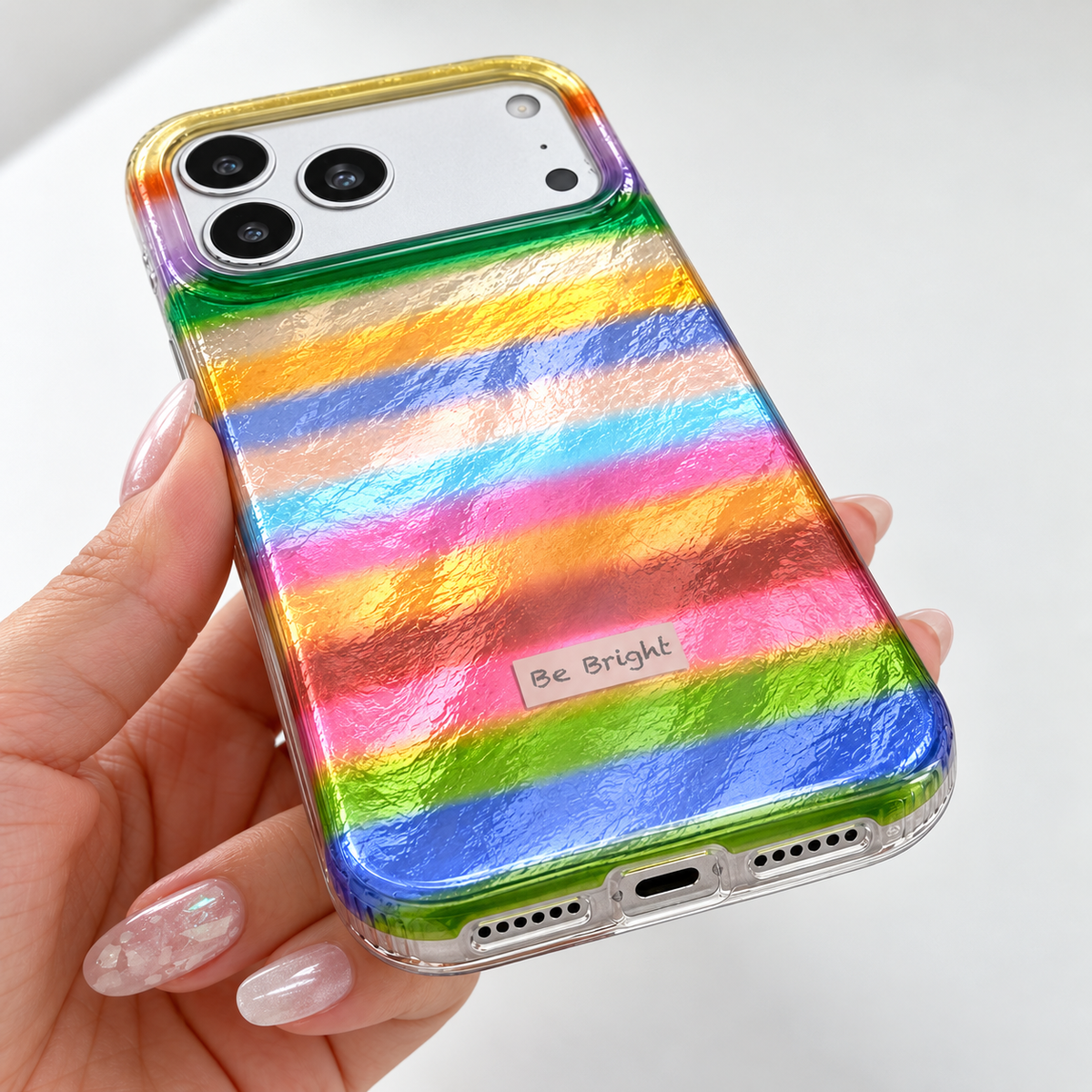 Be Bright rainbow stripe iPhone case — bottom edge and openings close-up.