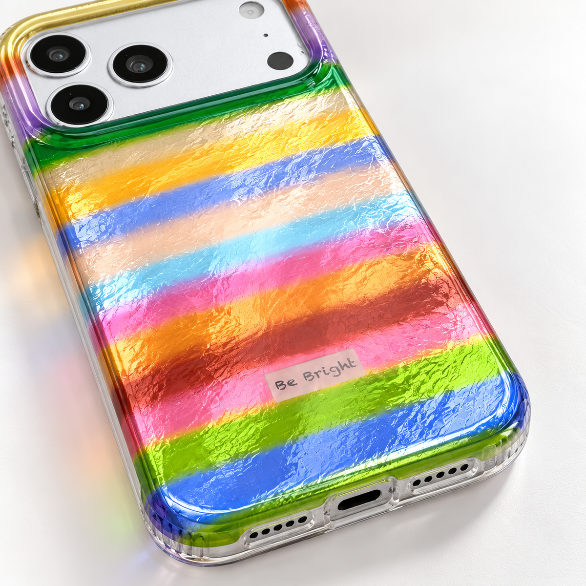 Be Bright rainbow stripe iPhone case — rounded lower corner detail.