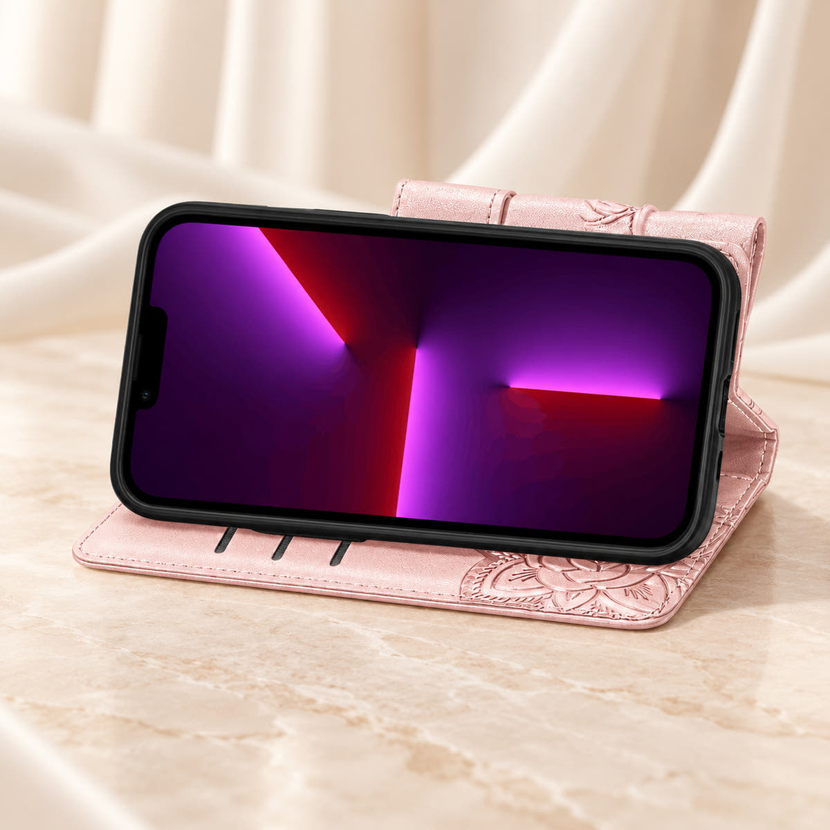 Butterfly iPhone wallet case in Baby Pink folded into its landscape stand, with the original interior card-slot edges visible.
