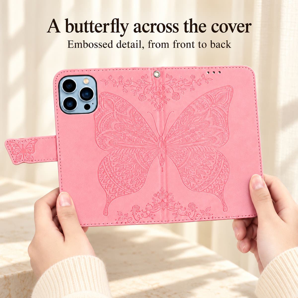 Pink Butterfly wallet phone case opened to show the complete embossed butterfly spanning the outside front and back covers.