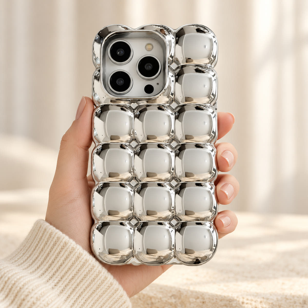 Silver Chrome Bubble Bear iPhone case — handheld front view