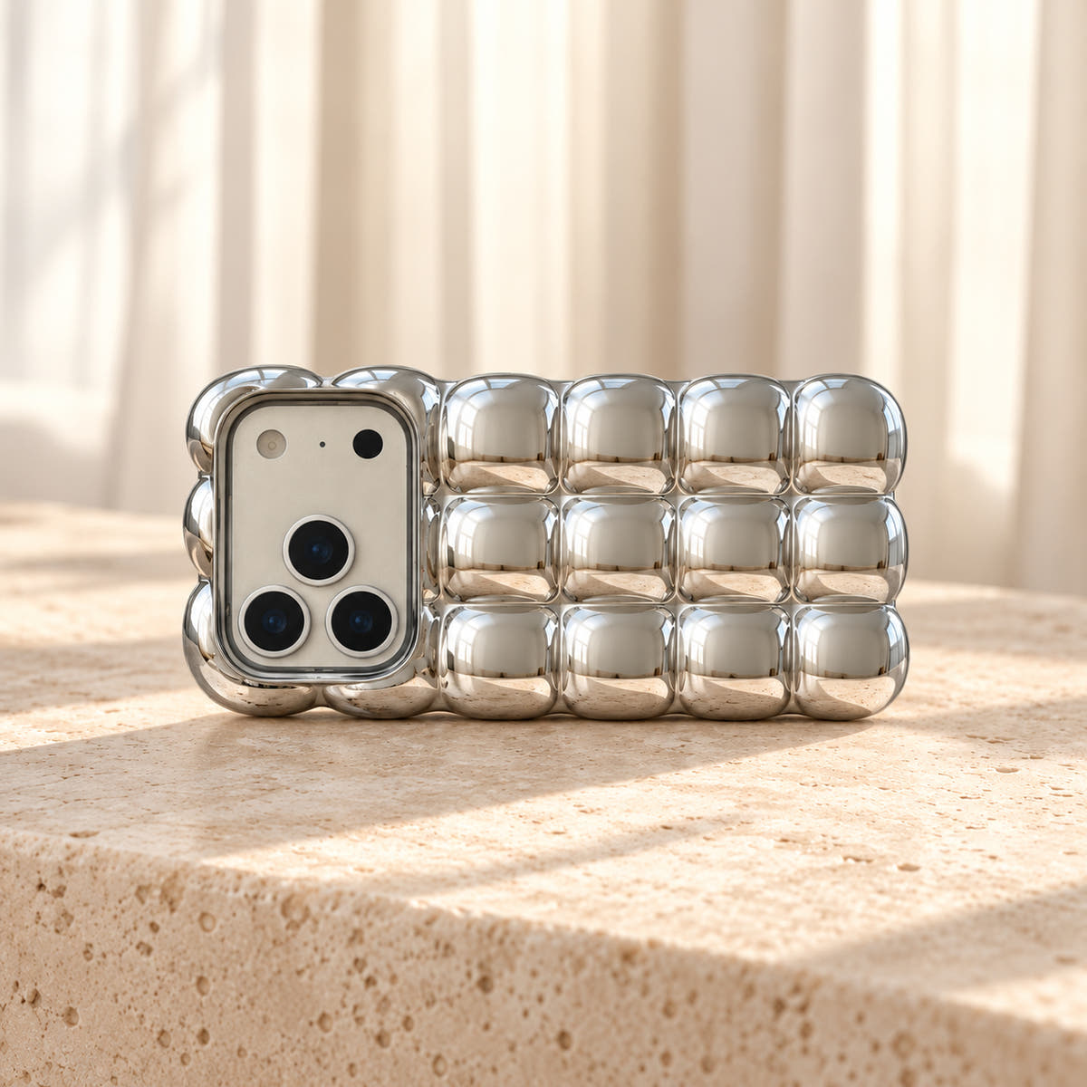 Silver Chrome Bubble Bear iPhone case — landscape tabletop view