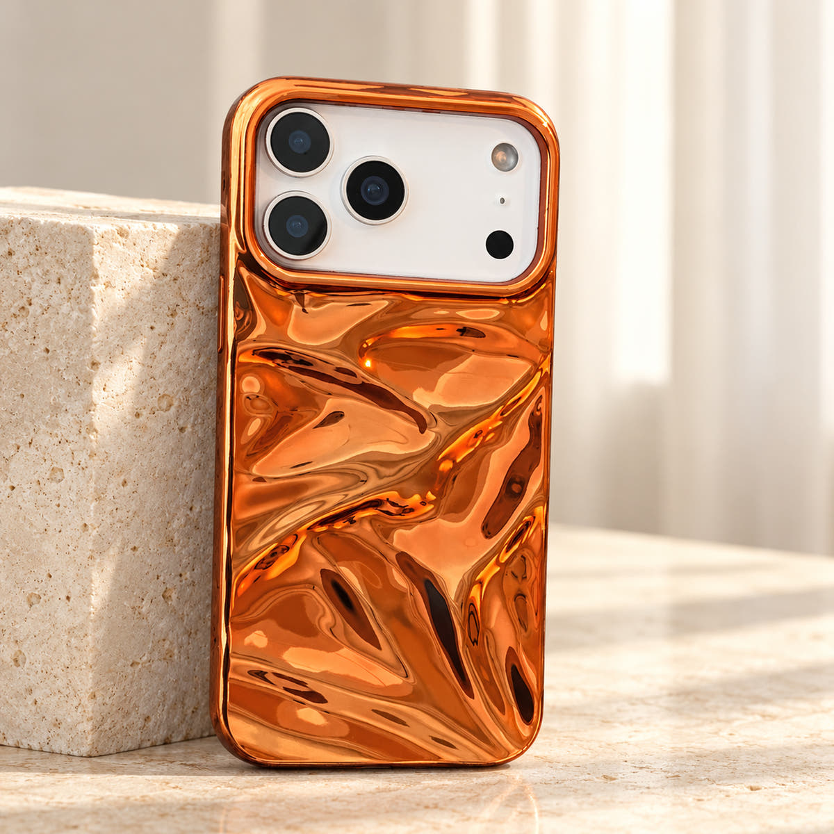 Copper-orange Chrome Wave iPhone case — standing plinth view