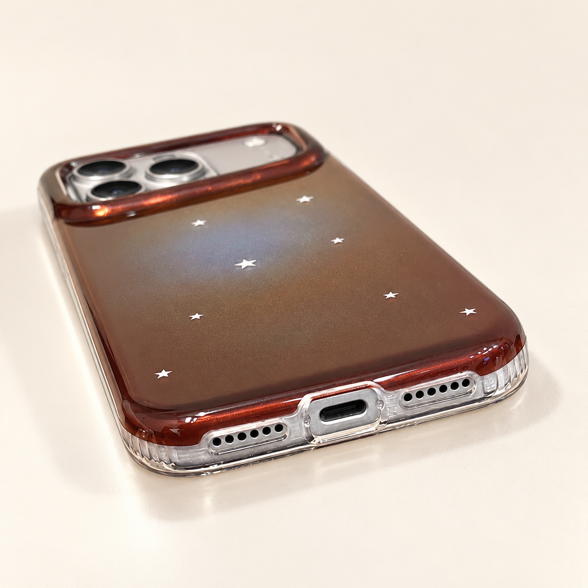 Copper Nebula case bottom edge with clear frame, charging opening and speaker openings.