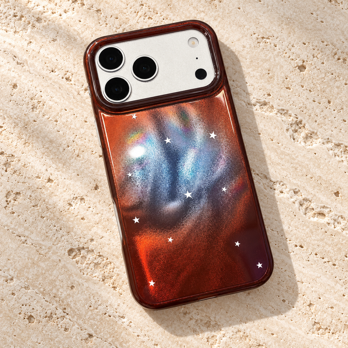 Copper Nebula Star iPhone Case in a diagonal rear flat lay on pale stone.
