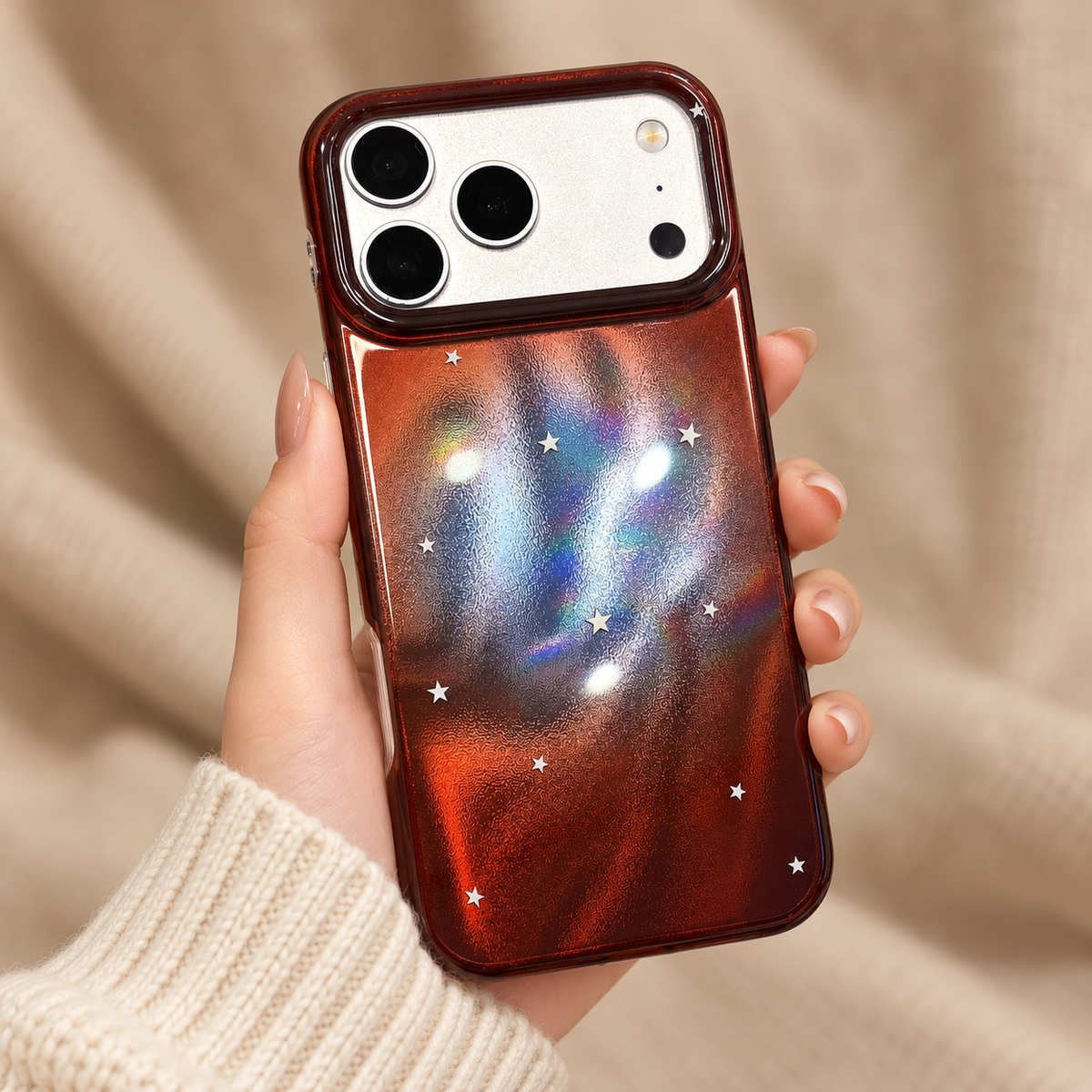Copper Nebula Star case held with a cream knit outfit, full rear design visible.