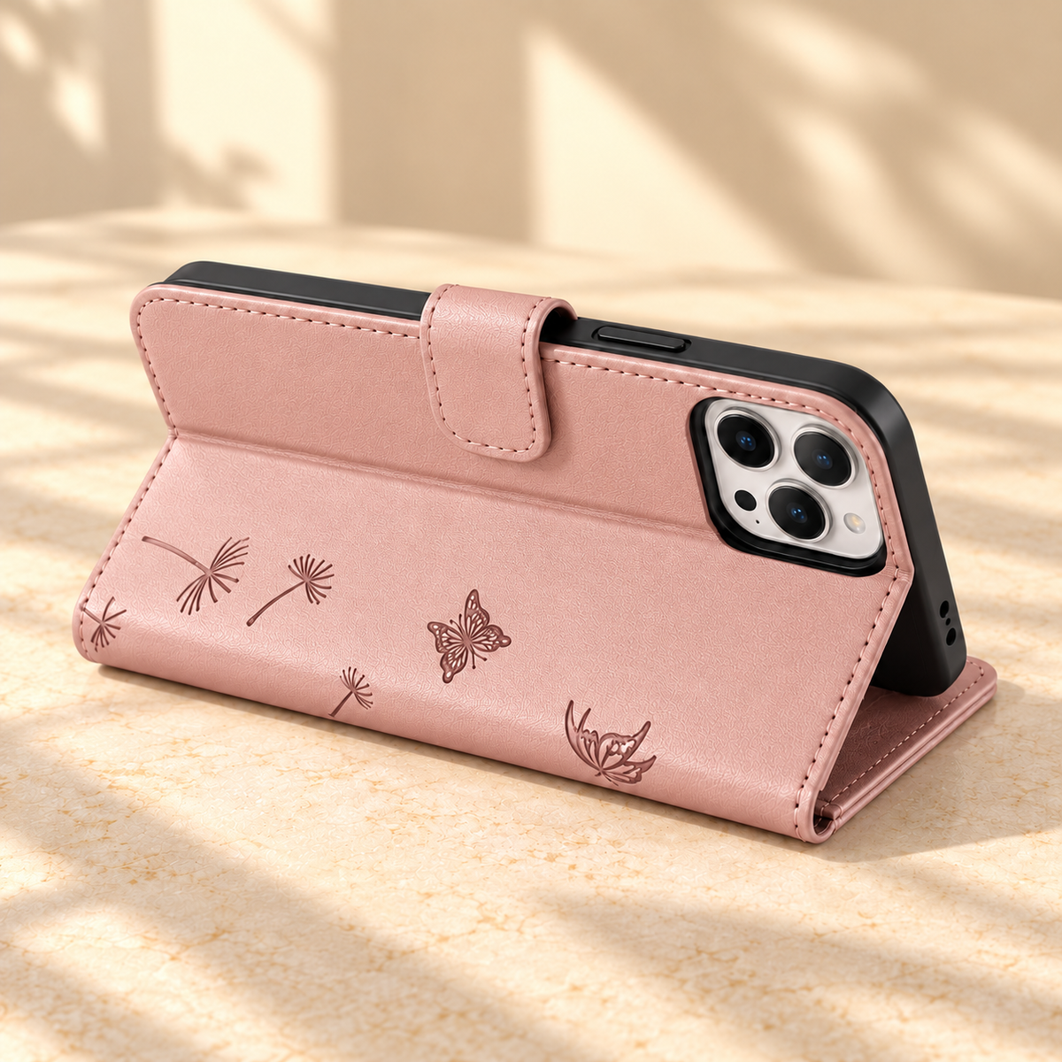 Rose Gold Dandelion and Butterfly wallet phone case folded into a landscape viewing stand.