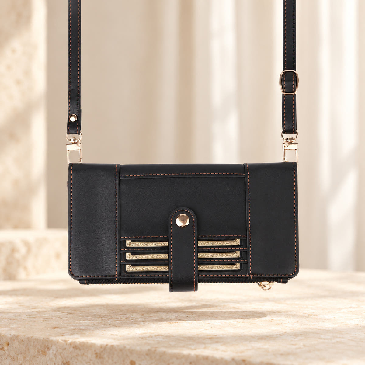 Elaris Crossbody iPhone wallet case in Black, landscape view with adjustable crossbody strap.