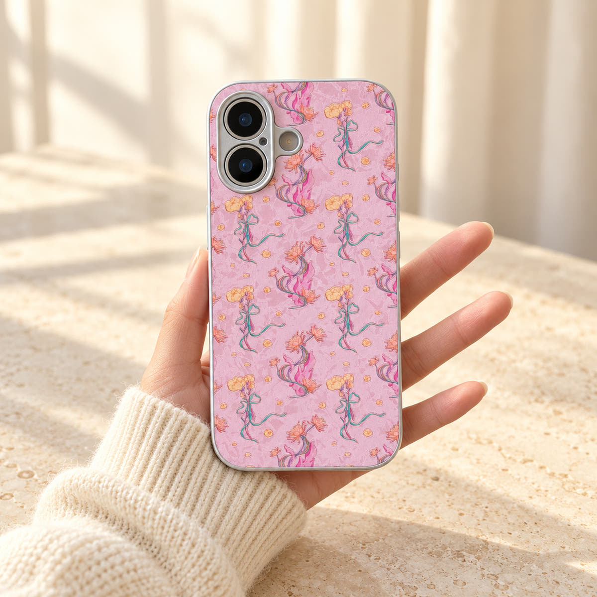 Pink Elysia Floral case held with the wallet removed, revealing the complete floral print across the back.