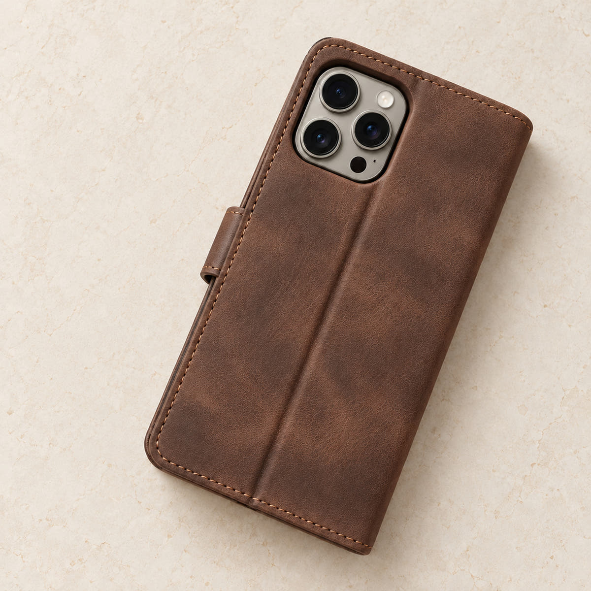 Floral embossed iPhone flip wallet case in Brown — plain rear panel and three-lens camera opening