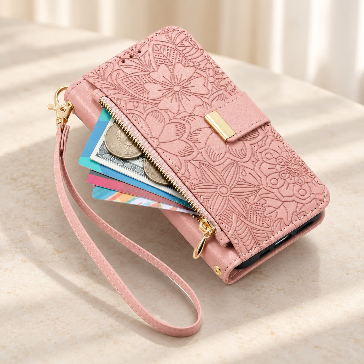Pink floral iPhone wallet case with the front zip pouch open, showing space for small essentials and the matching wrist strap