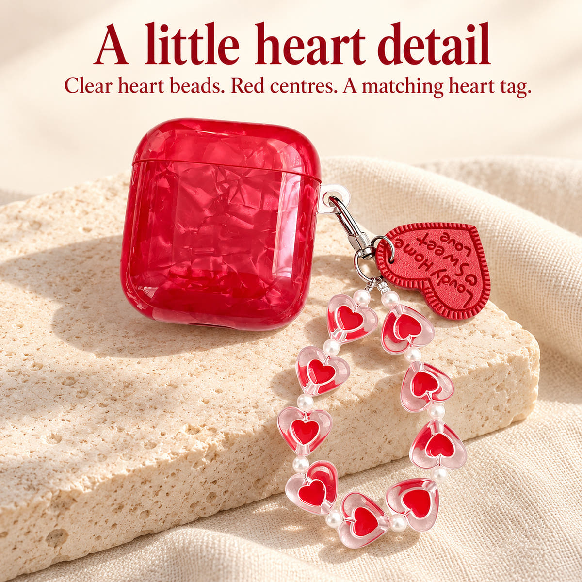 Garnet Marble AirPods case — heart strap panel with glossy red finish and heart-bead charm strap