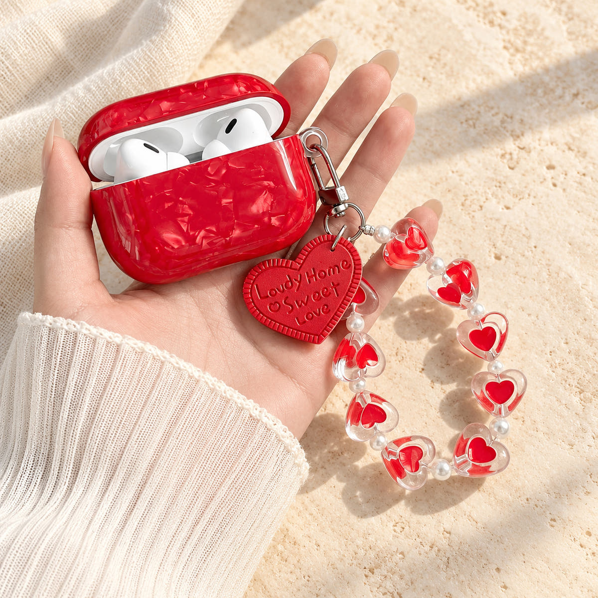 Garnet Marble AirPods case — open wide case with glossy red finish and heart-bead charm strap